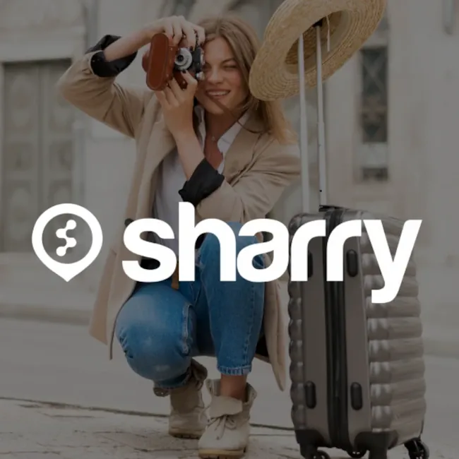 logo i nazwa firmy Sharry na tle dziewczyny, która fotografuje, i walizki